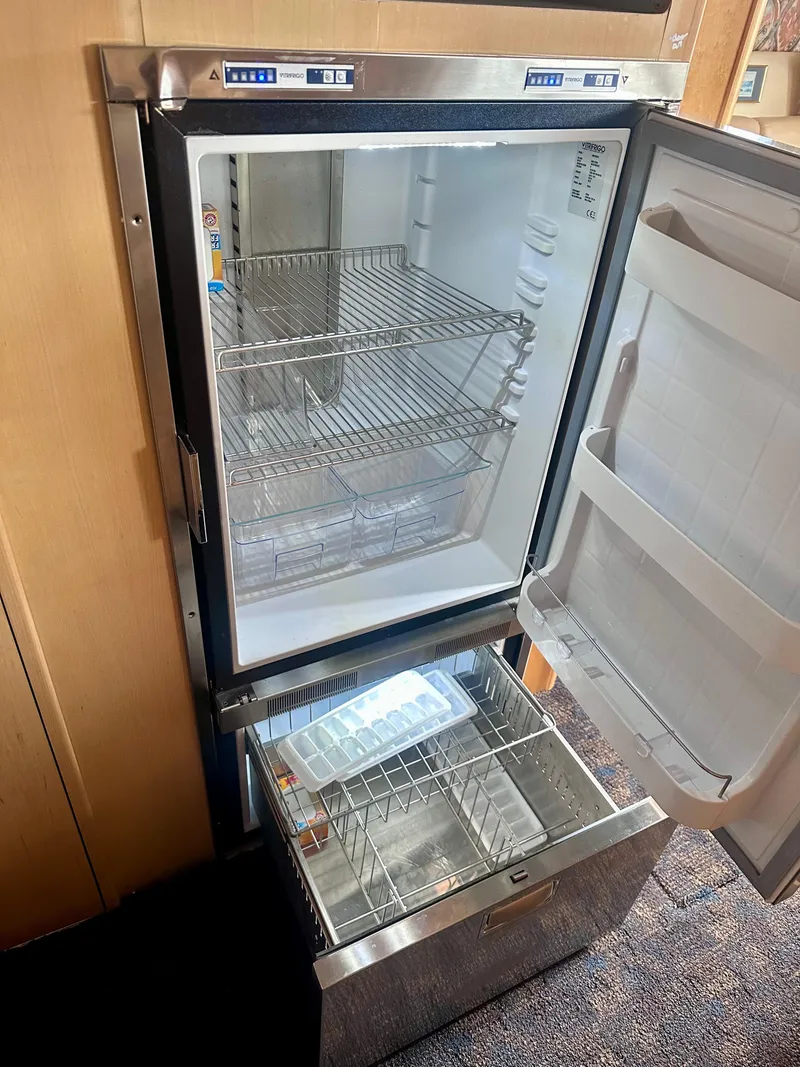 Slide: The Image of 1997 Carver 350 Mariner refrigerator with open door, showing empty shelves and ice tray. - 30
