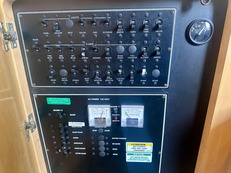 Slide: The Image of Control panel of a 1997 Carver 350 Mariner boat, featuring switches and gauges. - 32