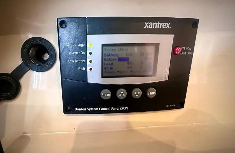Slide: The Image of Xantrex system control panel on 1997 Carver 350 Mariner, displaying battery status. - 33