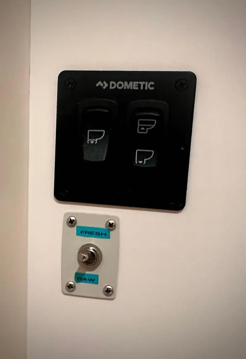 Slide: The Image of Control panel with switches labeled "Dometic" and toggle for "Fresh" and "Raw" on Carver 350 Mariner. - 38