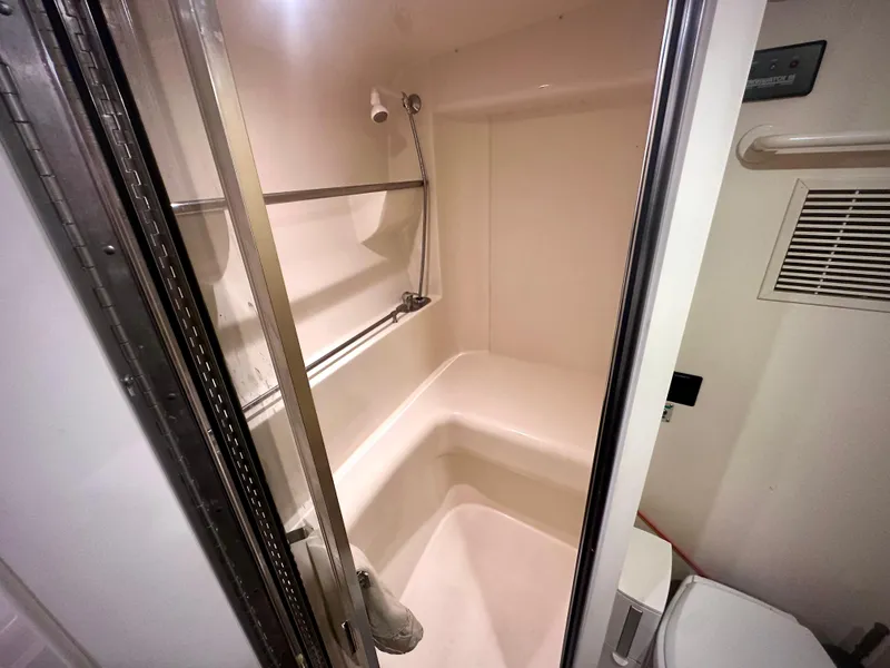 Slide: The Image of Bathroom interior of 1997 Carver 350 Mariner yacht, featuring shower and toilet. - 39