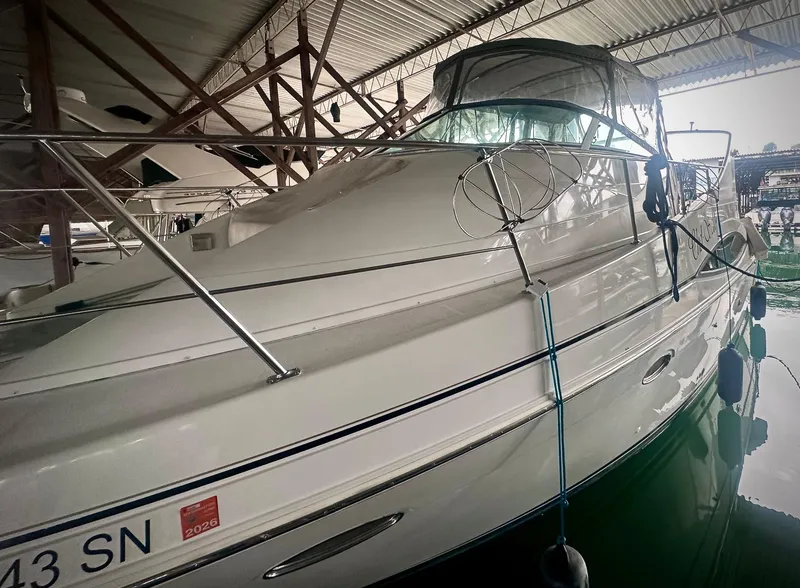 Slide: The Image of 1997 Carver 350 Mariner yacht docked in a covered marina. - 4