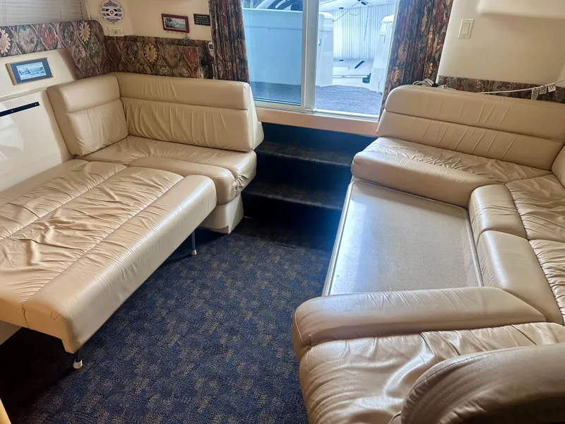 Slide: The Image of Interior of a 1997 Carver 350 Mariner yacht with beige leather seating and carpeted floor. - 40