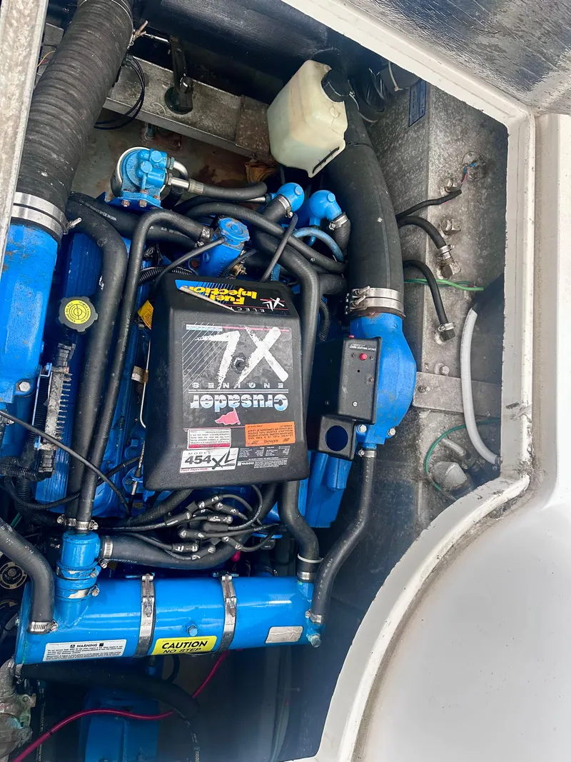 Slide: The Image of Engine compartment of a 1997 Carver 350 Mariner, featuring a Crusader 7.4L engine. - 41