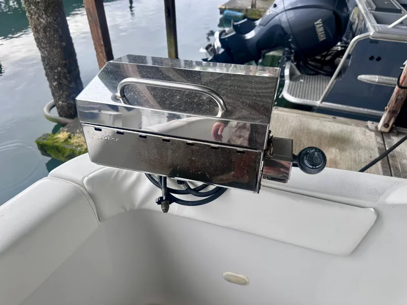 Slide: The Image of Stainless steel grill on a 1997 Carver 350 Mariner boat, docked by the water. - 44
