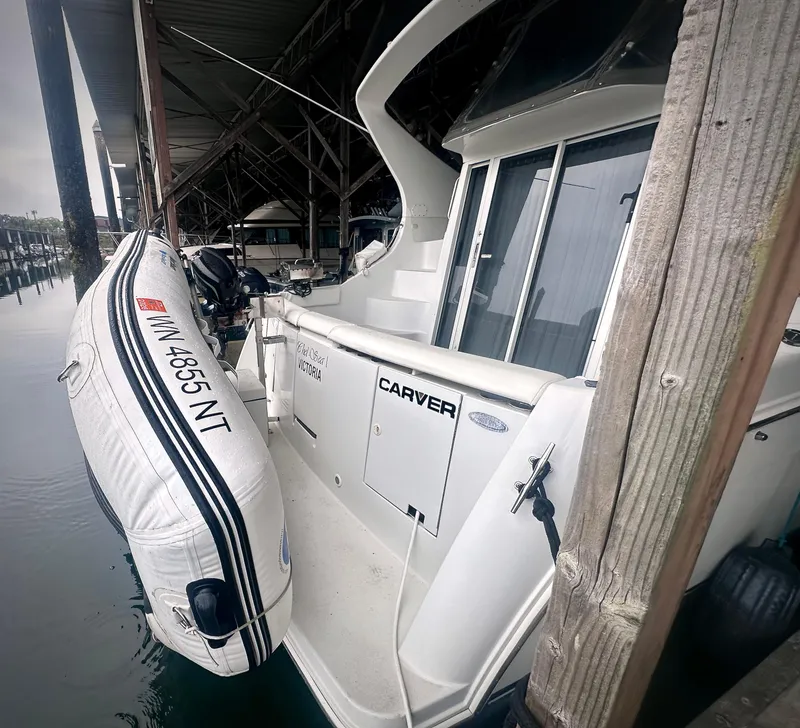 Slide: The Image of 1997 Carver 350 Mariner docked with attached inflatable boat. - 6