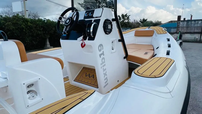 Slide: The Image of 2025 Aqvaboats Luxrib 19, sleek design, luxurious seating, modern dashboard, outdoor setting. - 11