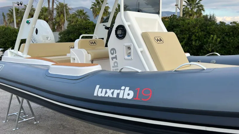 Slide: The Image of Aqvaboats Luxrib 19, 2025 model, sleek design with beige seating and modern features. - 21