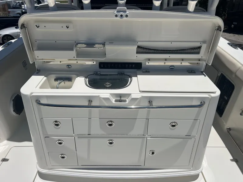 Slide: The Image of 2017 Boston Whaler 350 Outrage boat console with storage and sink. - 10