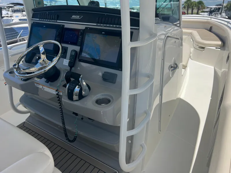 Slide: The Image of 2017 Boston Whaler 350 Outrage helm with dual screens and steering wheel. - 11