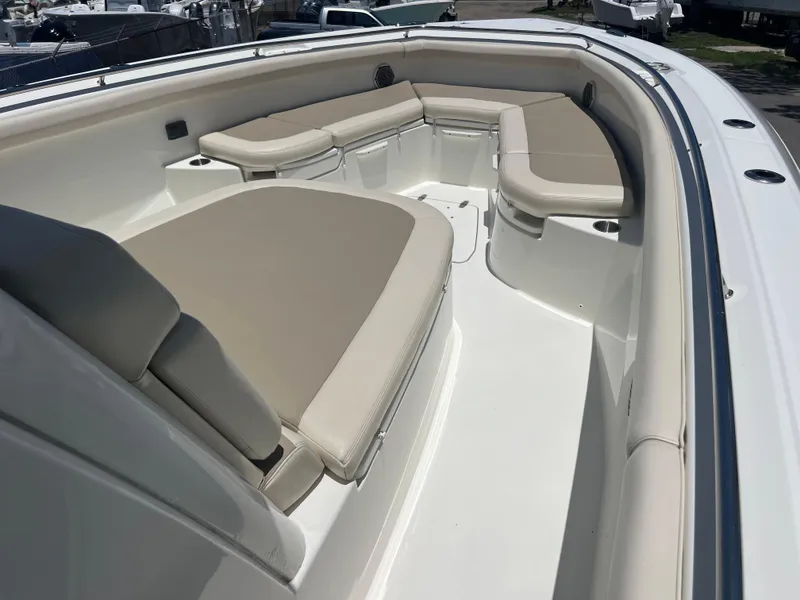 Slide: The Image of 2017 Boston Whaler 350 Outrage boat with spacious seating area and beige cushions. - 15