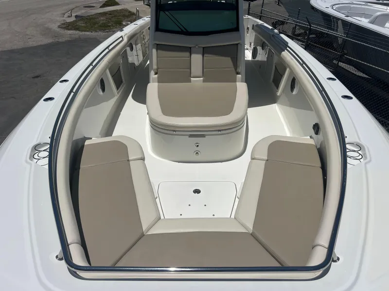 Slide: The Image of 2017 Boston Whaler 350 Outrage boat interior with beige seating and spacious layout. - 16
