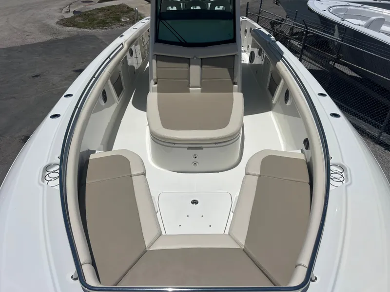 Slide: The Image of 2017 Boston Whaler 350 Outrage boat interior with beige seating and spacious deck. - 17