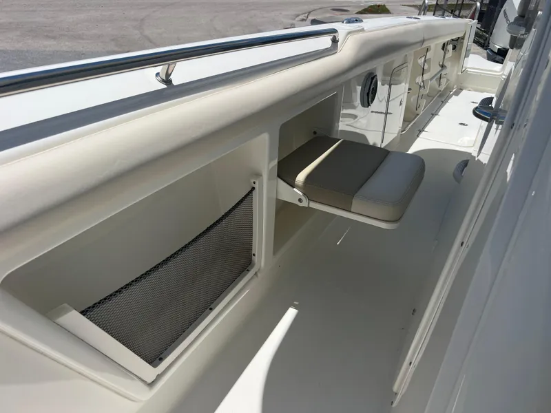 Slide: The Image of 2017 Boston Whaler 350 Outrage interior with seating and storage compartments. - 20