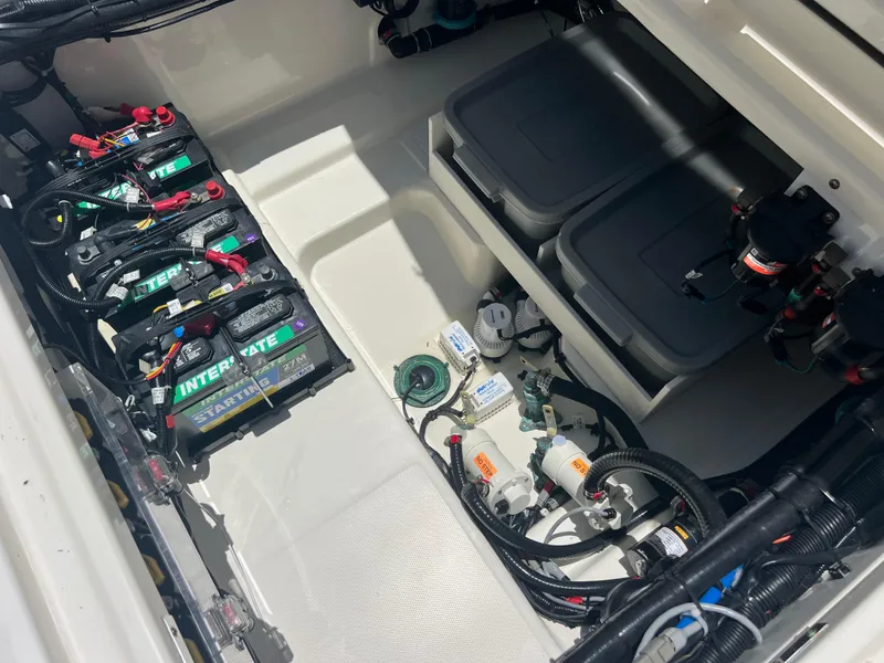 Slide: The Image of 2017 Boston Whaler 350 Outrage battery compartment with wiring and storage boxes. - 27