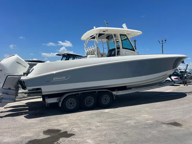 Slide: The Image of 2017 Boston Whaler 350 Outrage boat on trailer under clear blue sky. - 3