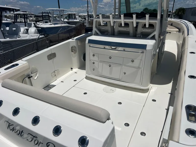Slide: The Image of 2017 Boston Whaler 350 Outrage boat interior with seating and storage compartments. - 7