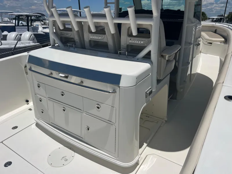Slide: The Image of 2017 Boston Whaler 350 Outrage interior with seating and storage compartments. - 8