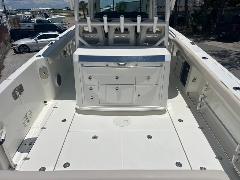 Slide: The Image of 2017 Boston Whaler 350 Outrage boat interior with seating and storage compartments. - 9