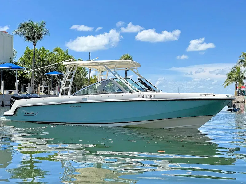 The Image of 2016 Boston Whaler 270 Vantage boat on calm water, under a clear blue sky. - 1