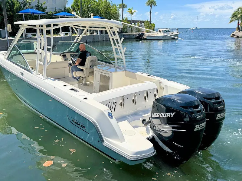 Slide: The Image of 2016 Boston Whaler 270 Vantage boat with dual Mercury engines on a sunny day. - 10