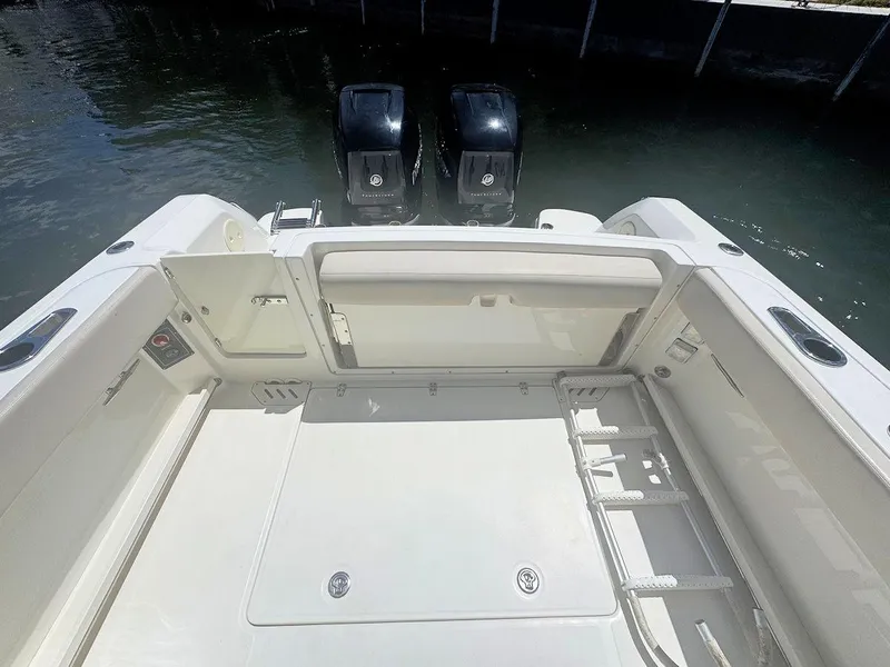 Slide: The Image of 2016 Boston Whaler 270 Vantage boat deck with twin outboard engines. - 11