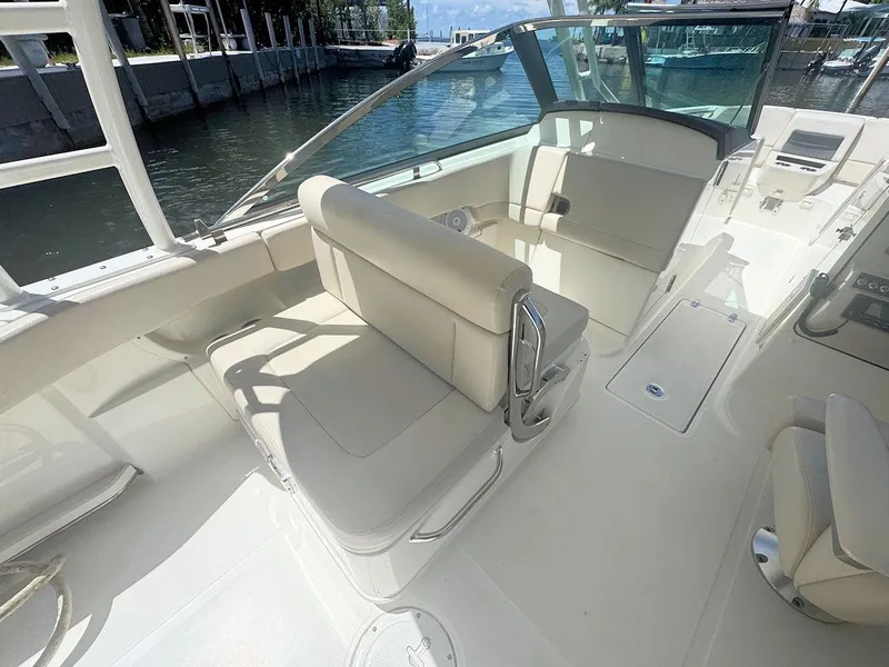 Slide: The Image of 2016 Boston Whaler 270 Vantage boat interior with seating and open deck view. - 13