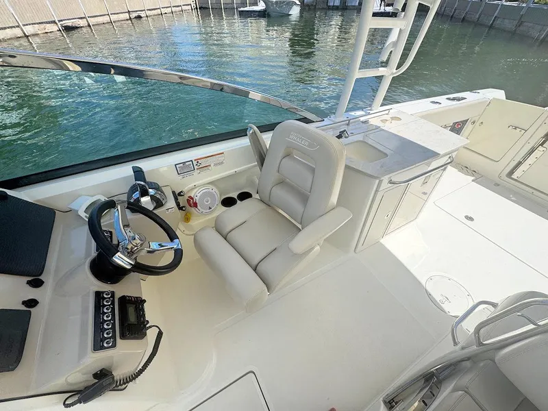 Slide: The Image of 2016 Boston Whaler 270 Vantage boat interior with steering wheel and seating. - 15
