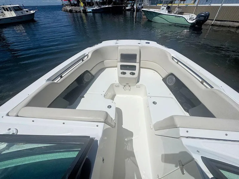Slide: The Image of 2016 Boston Whaler 270 Vantage boat interior with seating, docked at marina. - 17