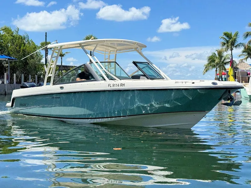 Slide: The Image of 2016 Boston Whaler 270 Vantage boat on clear water under blue sky. - 3
