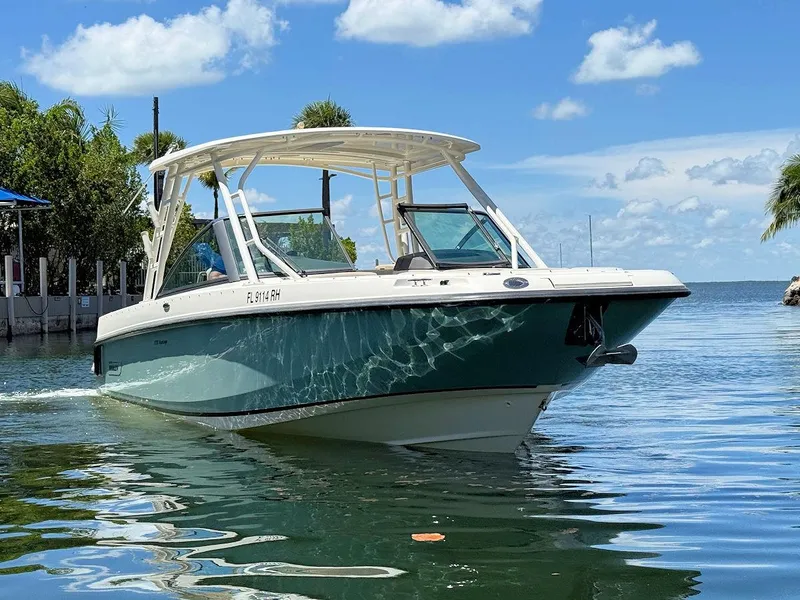 Slide: The Image of 2016 Boston Whaler 270 Vantage boat on calm water under a clear blue sky. - 4