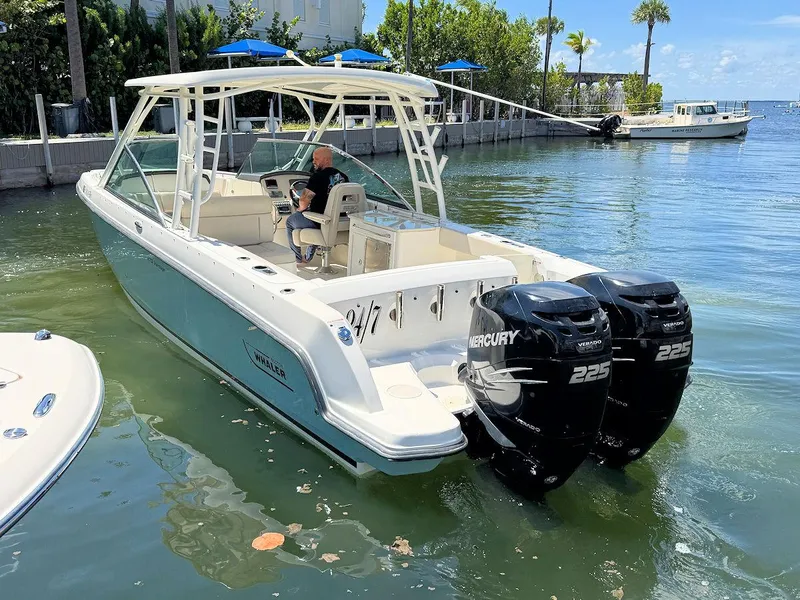 Slide: The Image of 2016 Boston Whaler 270 Vantage boat with dual Mercury 225 engines on calm water. - 9