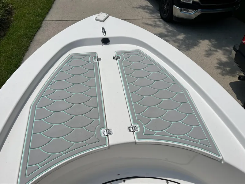 Slide: The Image of 2016 Sportsman Island Bay 18 boat deck with stylish gray and teal padding. - 11