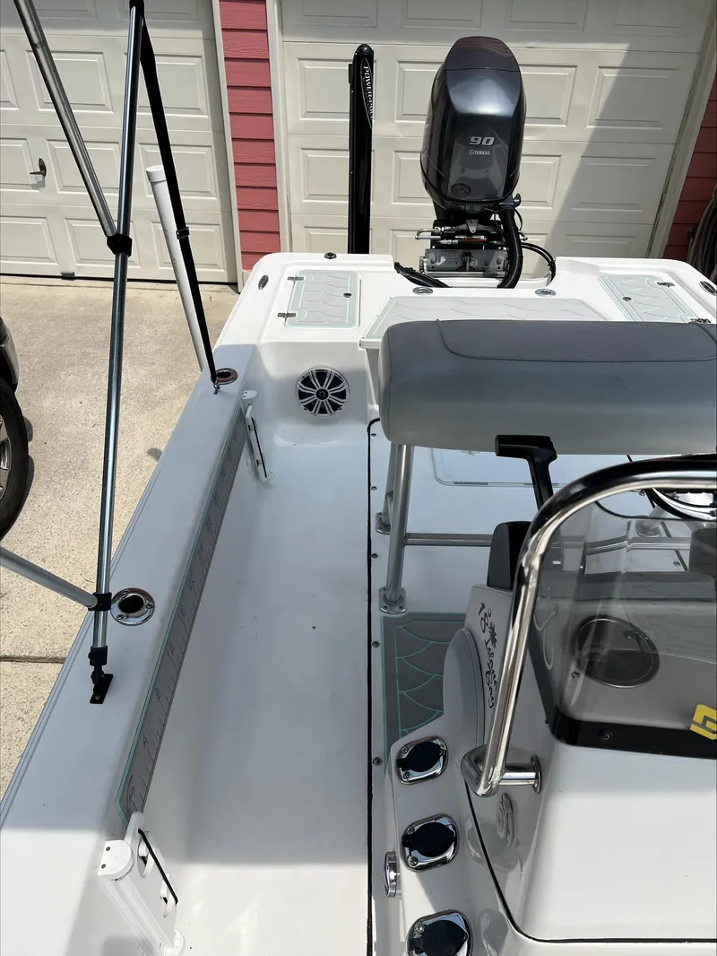 Slide: The Image of 2016 Sportsman Island Bay 18 boat interior with motor, parked near garage. - 14