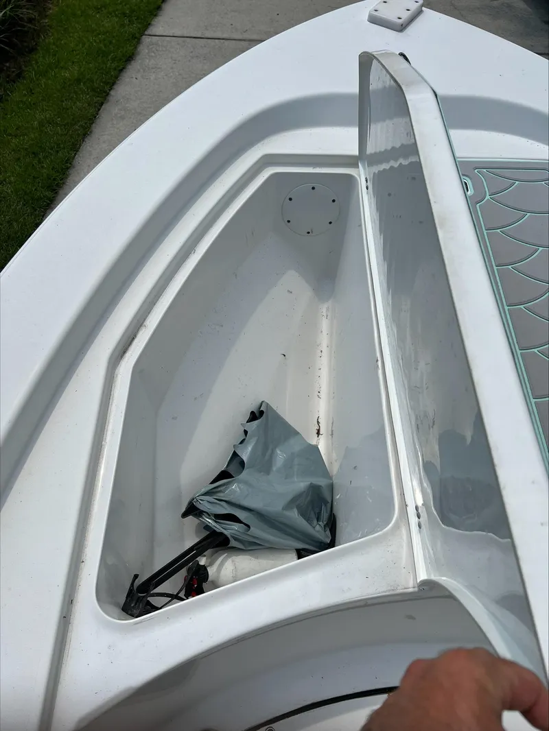 Slide: The Image of Open storage compartment on 2016 Sportsman Island Bay 18 boat, showing interior space. - 18