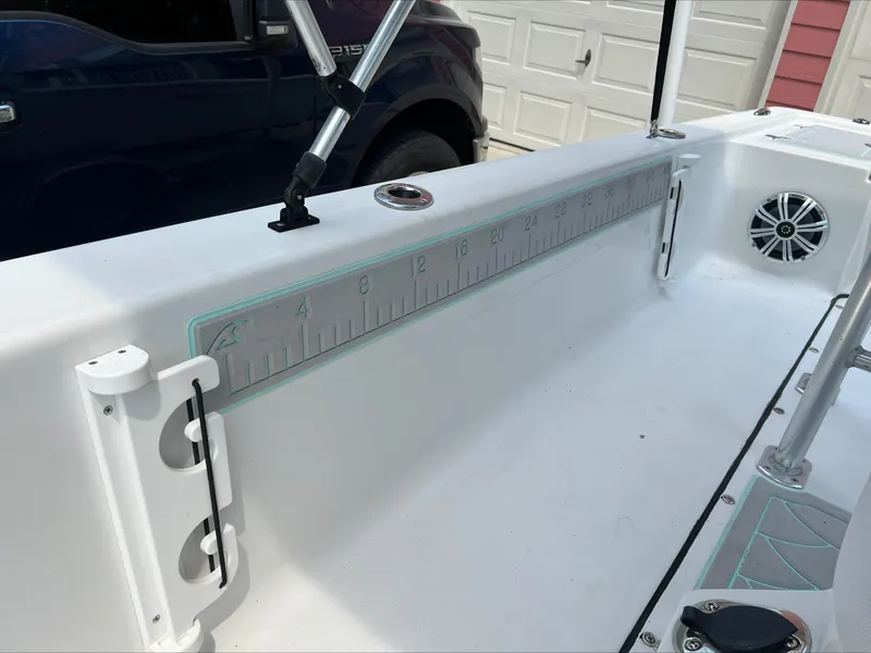 Slide: The Image of 2016 Sportsman Island Bay 18 boat interior with measuring ruler and speaker. - 19