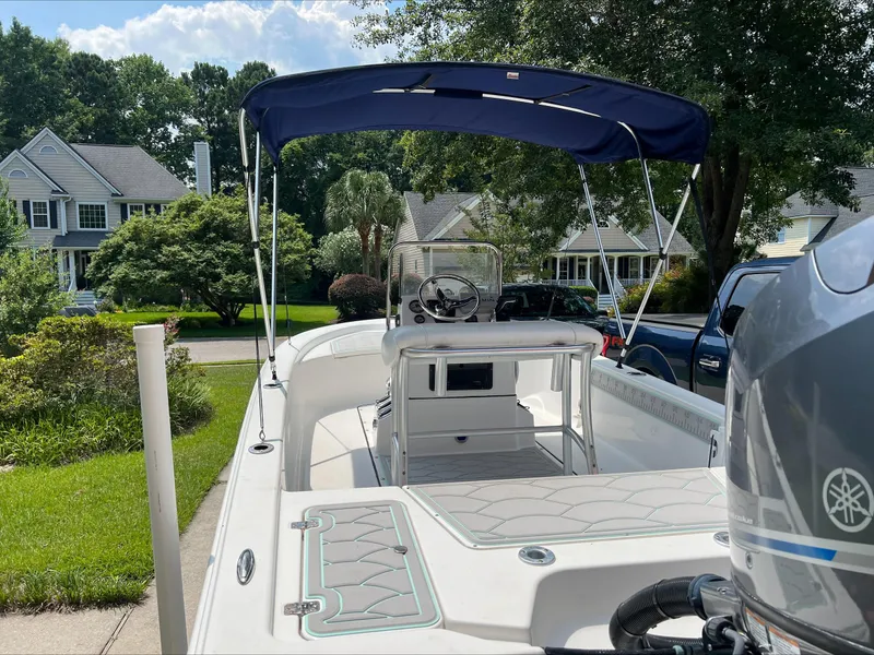 Slide: The Image of 2016 Sportsman Island Bay 18 boat with canopy, parked in a suburban neighborhood. - 4