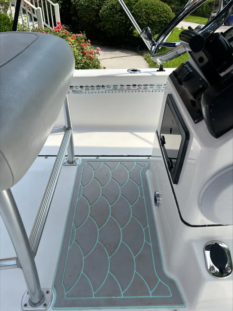 Slide: The Image of 2016 Sportsman Island Bay 18 boat interior with patterned floor mat and steering console. - 5