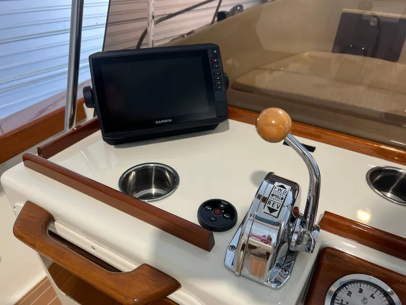 Slide: The Image of 1974 Chris-Craft Dory boat dashboard with Garmin display and control lever. - 14