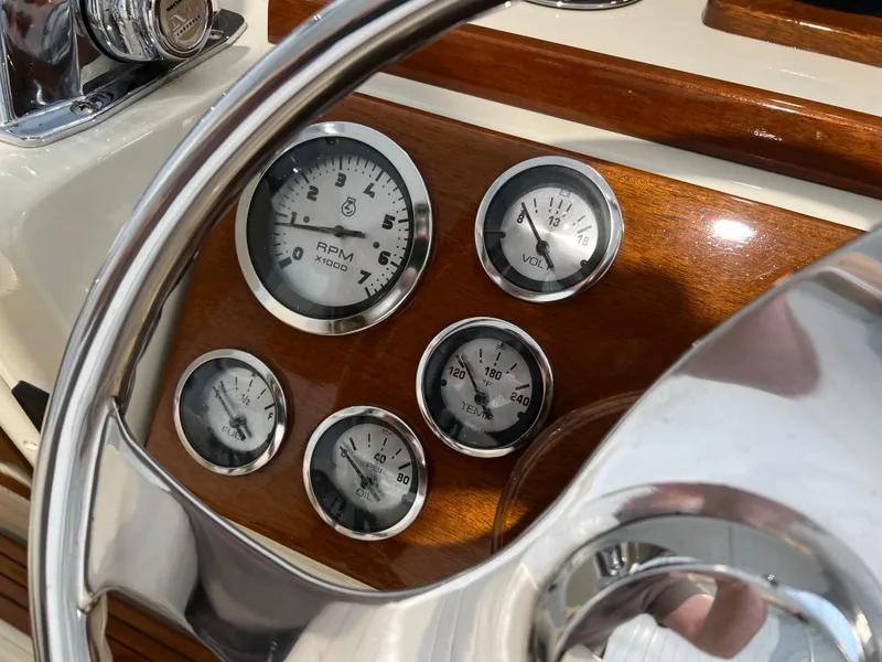 Slide: The Image of 1974 Chris-Craft Dory dashboard with gauges and wooden paneling. - 15