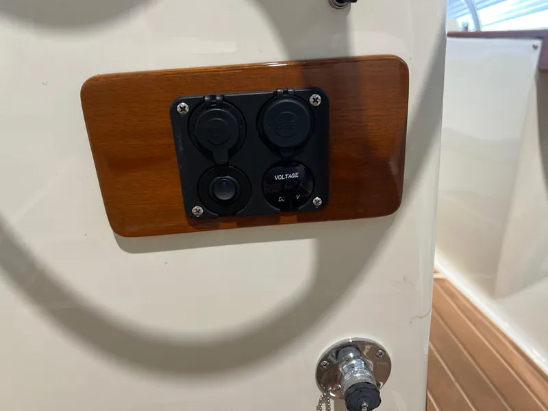 Slide: The Image of 1974 Chris-Craft Dory boat dashboard with voltage panel and wooden trim. - 16