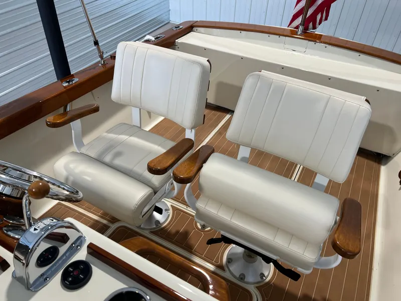 Slide: The Image of 1974 Chris-Craft Dory boat interior with white seats and wooden accents. - 17