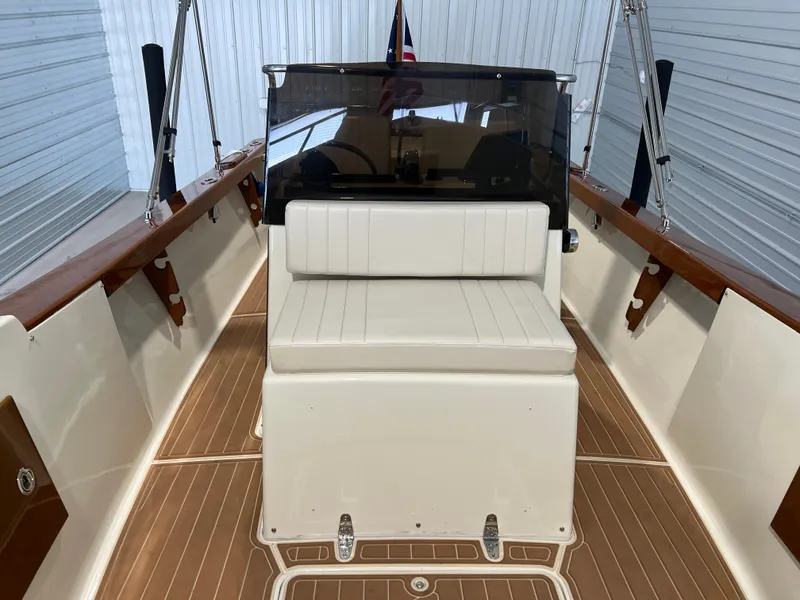 Slide: The Image of 1974 Chris-Craft Dory boat interior with white seating and wooden accents. - 20