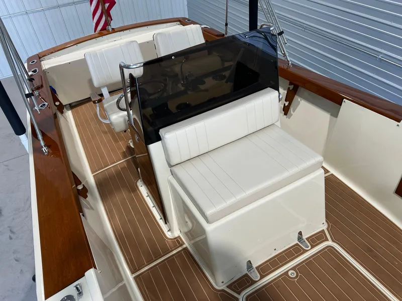 Slide: The Image of 1974 Chris-Craft Dory boat interior with white seating and wooden accents. - 21