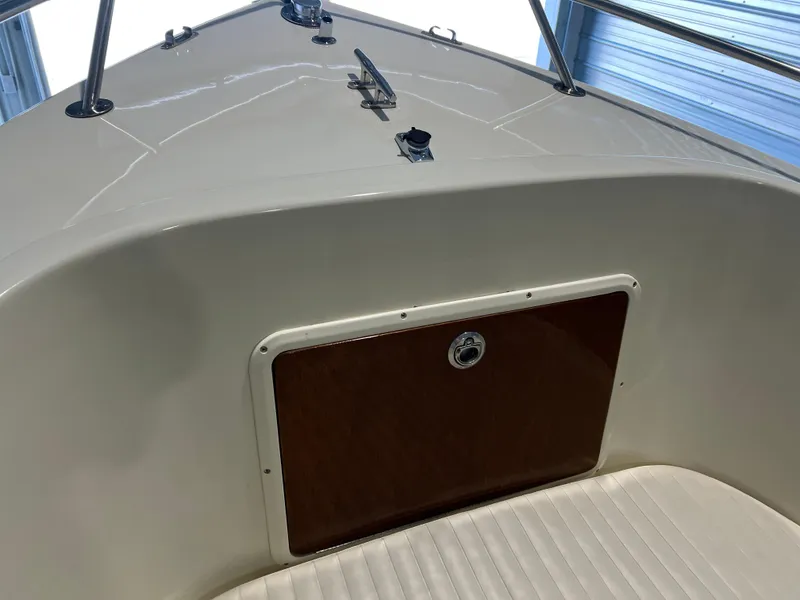 Slide: The Image of 1974 Chris-Craft Dory boat interior with white and wood accents. - 22