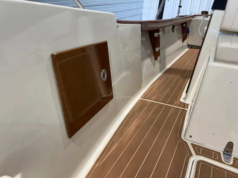 Slide: The Image of 1974 Chris-Craft Dory boat interior with wooden accents and sleek design. - 24