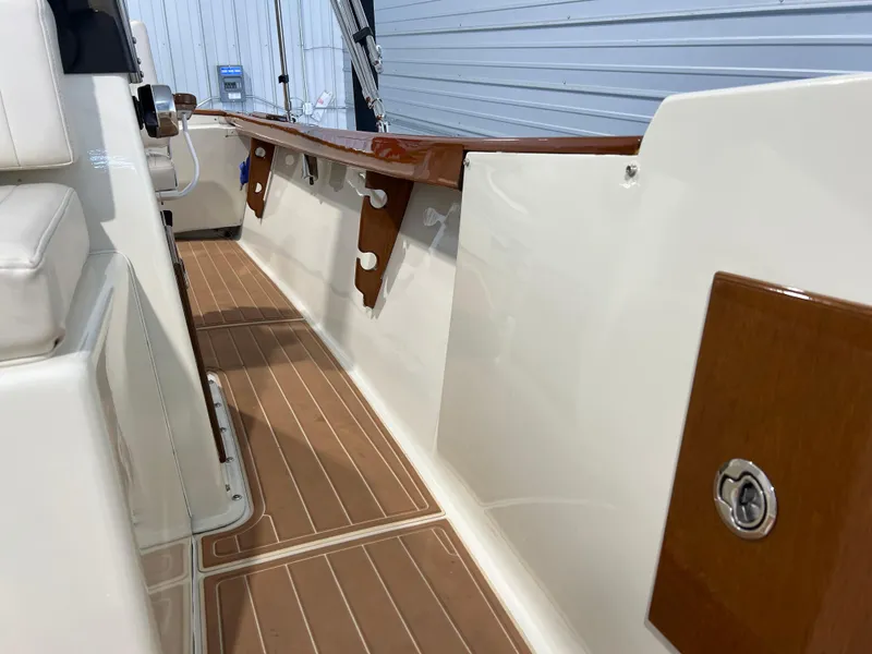 Slide: The Image of 1974 Chris-Craft Dory boat interior with wooden accents and cushioned seating. - 26