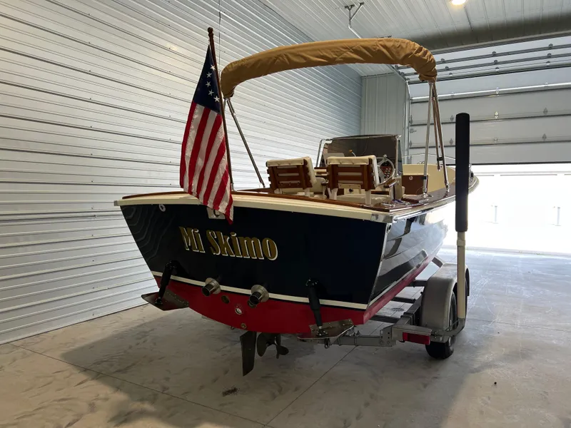 Slide: The Image of 1974 Chris-Craft Dory boat with American flag in a garage. - 4