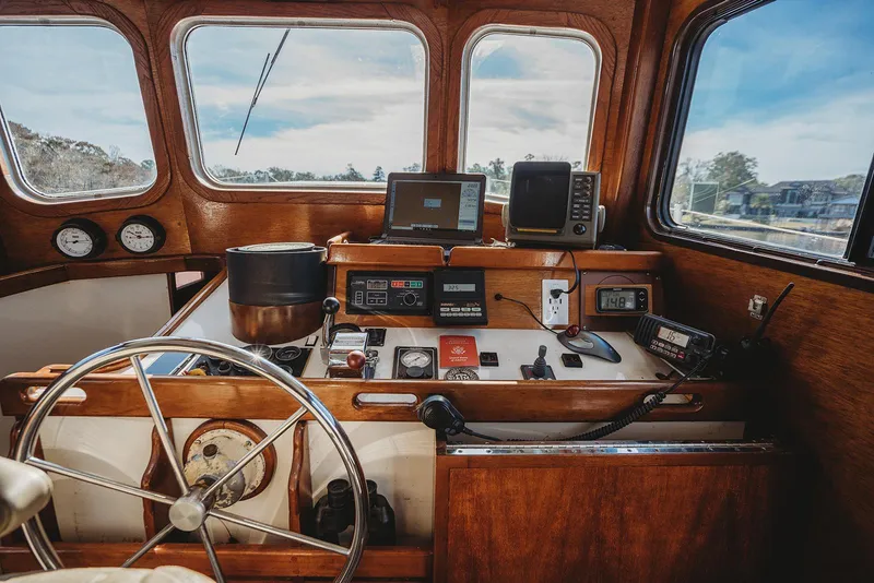 Slide: The Image of 1991 Trawler 37 helm with navigation equipment and wooden dashboard. - 20