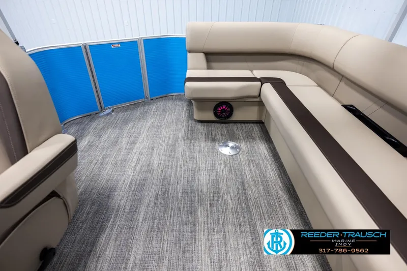 Slide: The Image of 2025 Bennington 21 SL pontoon boat interior with beige seating and blue paneling. - 14